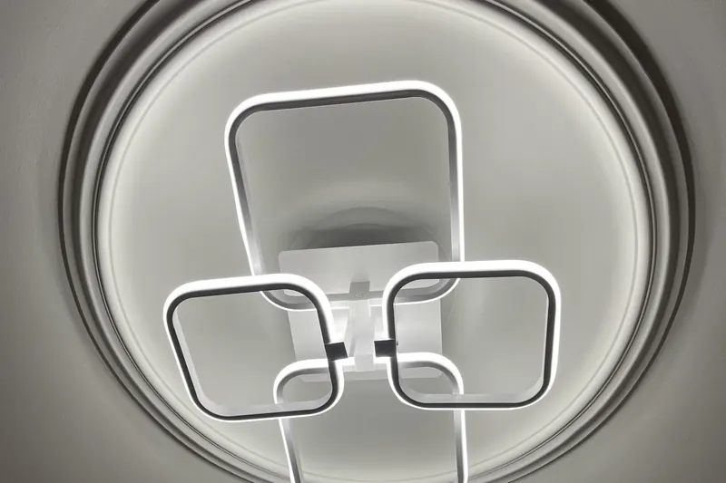 Modern LED ceiling light with linked square frames, fitted and switched on