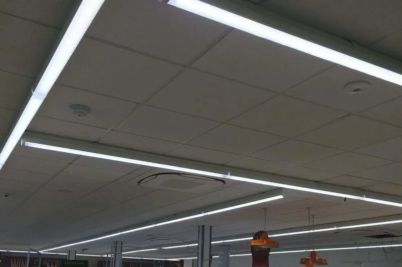 Long runs of LED strip lighting across a shop ceiling